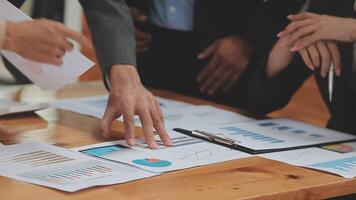 Financial analysts analyze business financial reports on a digital tablet planning investment project during a discussion at a meeting of corporate showing the results of their successful teamwork. video