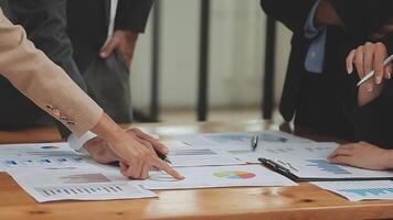 Financial analysts analyze business financial reports on a digital tablet planning investment project during a discussion at a meeting of corporate showing the results of their successful teamwork. video