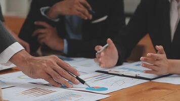 Financial analysts analyze business financial reports on a digital tablet planning investment project during a discussion at a meeting of corporate showing the results of their successful teamwork. video