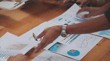 Financial analysts analyze business financial reports on a digital tablet planning investment project during a discussion at a meeting of corporate showing the results of their successful teamwork. video