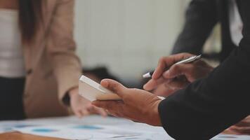 Financial analysts analyze business financial reports on a digital tablet planning investment project during a discussion at a meeting of corporate showing the results of their successful teamwork. video
