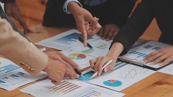 Financial analysts analyze business financial reports on a digital tablet planning investment project during a discussion at a meeting of corporate showing the results of their successful teamwork. video