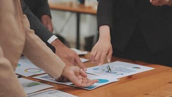 Financial analysts analyze business financial reports on a digital tablet planning investment project during a discussion at a meeting of corporate showing the results of their successful teamwork. video