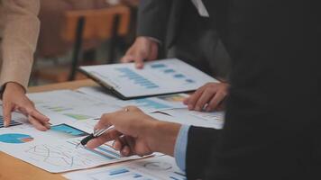 Financial analysts analyze business financial reports on a digital tablet planning investment project during a discussion at a meeting of corporate showing the results of their successful teamwork. video