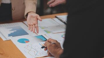 Financial analysts analyze business financial reports on a digital tablet planning investment project during a discussion at a meeting of corporate showing the results of their successful teamwork. video