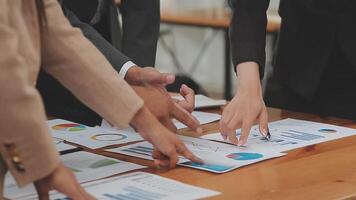 Financial analysts analyze business financial reports on a digital tablet planning investment project during a discussion at a meeting of corporate showing the results of their successful teamwork. video