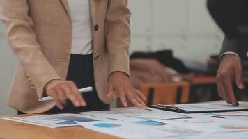 Financial analysts analyze business financial reports on a digital tablet planning investment project during a discussion at a meeting of corporate showing the results of their successful teamwork. video