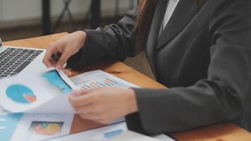 Financial analysts analyze business financial reports on a digital tablet planning investment project during a discussion at a meeting of corporate showing the results of their successful teamwork. video