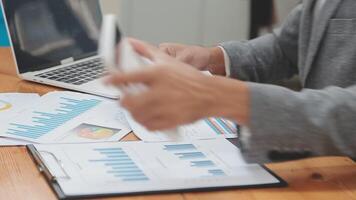 Financial analysts analyze business financial reports on a digital tablet planning investment project during a discussion at a meeting of corporate showing the results of their successful teamwork. video