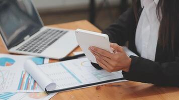 Financial analysts analyze business financial reports on a digital tablet planning investment project during a discussion at a meeting of corporate showing the results of their successful teamwork. video