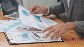 Financial analysts analyze business financial reports on a digital tablet planning investment project during a discussion at a meeting of corporate showing the results of their successful teamwork. video