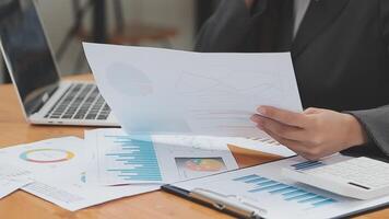 Financial analysts analyze business financial reports on a digital tablet planning investment project during a discussion at a meeting of corporate showing the results of their successful teamwork. video