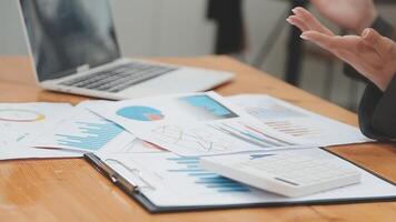 Financial analysts analyze business financial reports on a digital tablet planning investment project during a discussion at a meeting of corporate showing the results of their successful teamwork. video