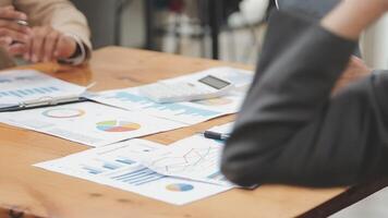 Financial analysts analyze business financial reports on a digital tablet planning investment project during a discussion at a meeting of corporate showing the results of their successful teamwork. video