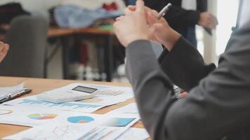 Financial analysts analyze business financial reports on a digital tablet planning investment project during a discussion at a meeting of corporate showing the results of their successful teamwork. video