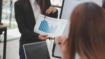 Financial analysts analyze business financial reports on a digital tablet planning investment project during a discussion at a meeting of corporate showing the results of their successful teamwork. video