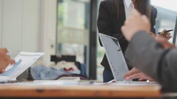 Financial analysts analyze business financial reports on a digital tablet planning investment project during a discussion at a meeting of corporate showing the results of their successful teamwork. video