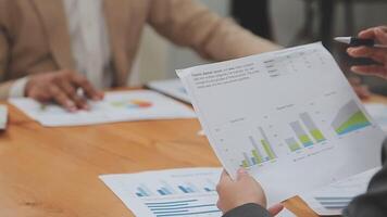 Financial analysts analyze business financial reports on a digital tablet planning investment project during a discussion at a meeting of corporate showing the results of their successful teamwork. video