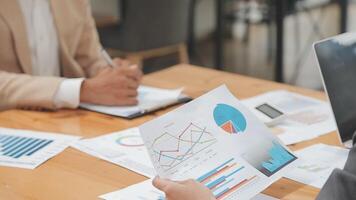 Financial analysts analyze business financial reports on a digital tablet planning investment project during a discussion at a meeting of corporate showing the results of their successful teamwork. video