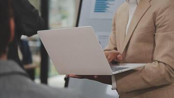 Financial analysts analyze business financial reports on a digital tablet planning investment project during a discussion at a meeting of corporate showing the results of their successful teamwork. video