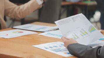 Financial analysts analyze business financial reports on a digital tablet planning investment project during a discussion at a meeting of corporate showing the results of their successful teamwork. video