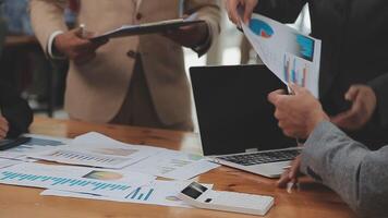 Financial analysts analyze business financial reports on a digital tablet planning investment project during a discussion at a meeting of corporate showing the results of their successful teamwork. video