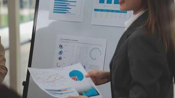 Financial analysts analyze business financial reports on a digital tablet planning investment project during a discussion at a meeting of corporate showing the results of their successful teamwork. video