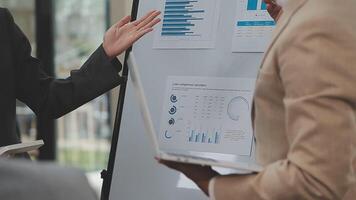 Financial analysts analyze business financial reports on a digital tablet planning investment project during a discussion at a meeting of corporate showing the results of their successful teamwork. video