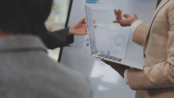 Financial analysts analyze business financial reports on a digital tablet planning investment project during a discussion at a meeting of corporate showing the results of their successful teamwork. video