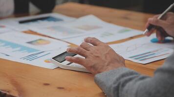 Financial analysts analyze business financial reports on a digital tablet planning investment project during a discussion at a meeting of corporate showing the results of their successful teamwork. video