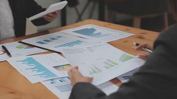 Financial analysts analyze business financial reports on a digital tablet planning investment project during a discussion at a meeting of corporate showing the results of their successful teamwork. video