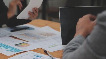 Financial analysts analyze business financial reports on a digital tablet planning investment project during a discussion at a meeting of corporate showing the results of their successful teamwork. video