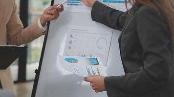 Financial analysts analyze business financial reports on a digital tablet planning investment project during a discussion at a meeting of corporate showing the results of their successful teamwork. video