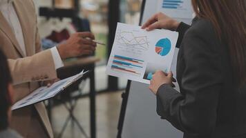 Financial analysts analyze business financial reports on a digital tablet planning investment project during a discussion at a meeting of corporate showing the results of their successful teamwork. video