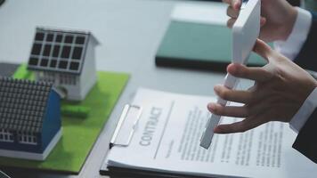 Architecture team and engineer are discussing and brainstorming on floor plan over the clean energy and power saving house design using solar panel for green industry and futuristic home development video