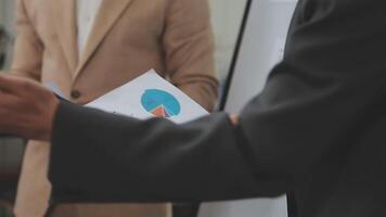 Financial analysts analyze business financial reports on a digital tablet planning investment project during a discussion at a meeting of corporate showing the results of their successful teamwork. video