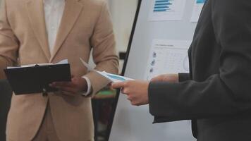 Financial analysts analyze business financial reports on a digital tablet planning investment project during a discussion at a meeting of corporate showing the results of their successful teamwork. video