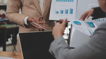 Financial analysts analyze business financial reports on a digital tablet planning investment project during a discussion at a meeting of corporate showing the results of their successful teamwork. video
