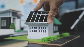 Architecture team and engineer are discussing and brainstorming on floor plan over the clean energy and power saving house design using solar panel for green industry and futuristic home development video