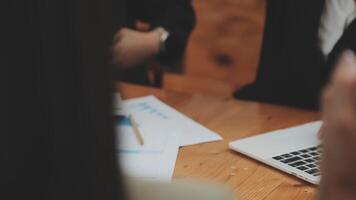 Financial analysts analyze business financial reports on a digital tablet planning investment project during a discussion at a meeting of corporate showing the results of their successful teamwork. video