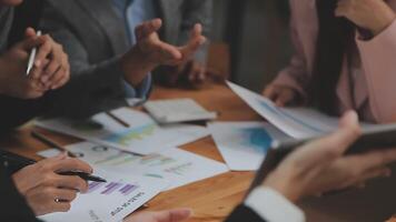 Financial analysts analyze business financial reports on a digital tablet planning investment project during a discussion at a meeting of corporate showing the results of their successful teamwork. video