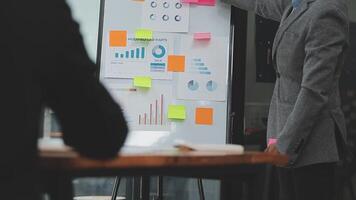 Financial analysts analyze business financial reports on a digital tablet planning investment project during a discussion at a meeting of corporate showing the results of their successful teamwork. video