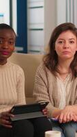 Start up company team talking during meeting sitting on couch listening and explaning to remote manager company strategy. Multiethnic coworkers discussing about startup financial company. video