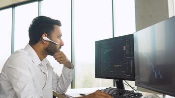 Indian trader broker checking stock trading data analysis concept working in office with financial graph video
