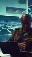 Vertical Special operations engineers examining surveillance footage to gather important information for a mission, working on reconnaissance in military headquarters. Army soldiers in command post. Camera B. video