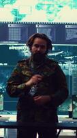 Vertical Brigadier general and his staff studying radar data on a holographic image, working with artificial intelligence and holography in a military base of operations. Ensure national safety. Camera B. video
