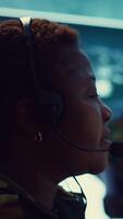 Vertical Woman military personnel tracking enemy vessels on the coast line territory, working on national safety and providing real time data to the dispatch center. Reconnaissance system. Camera B. video
