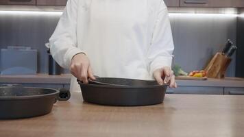 Close up of woman hands demonstrating new frying pans set for kitchen with a removable handle. Action. Concept of house utensils. video