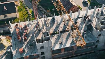 Drone Aerial Top View Of Construction Work, Top View Through A Construction Crane. Builders Build A House. Construction Work. video