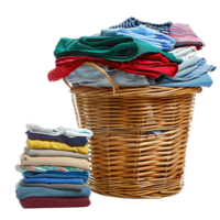 A wicker laundry basket overflowing with clean clothes, next to a stack of freshly laundered and folded garments isolated on a transparent background png